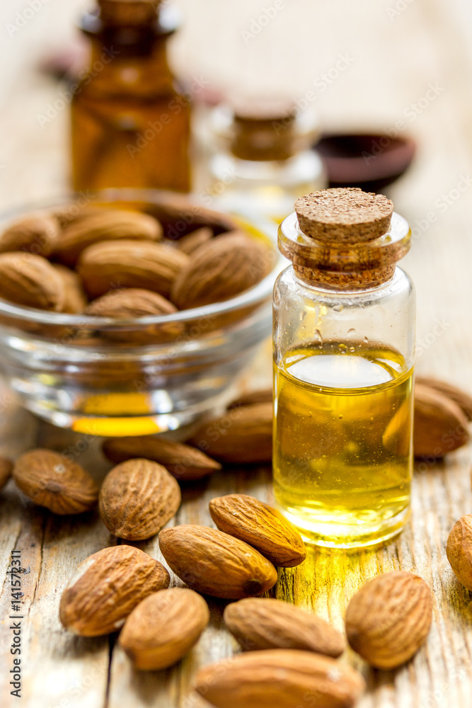 organic cosmetic with almond extract on table background