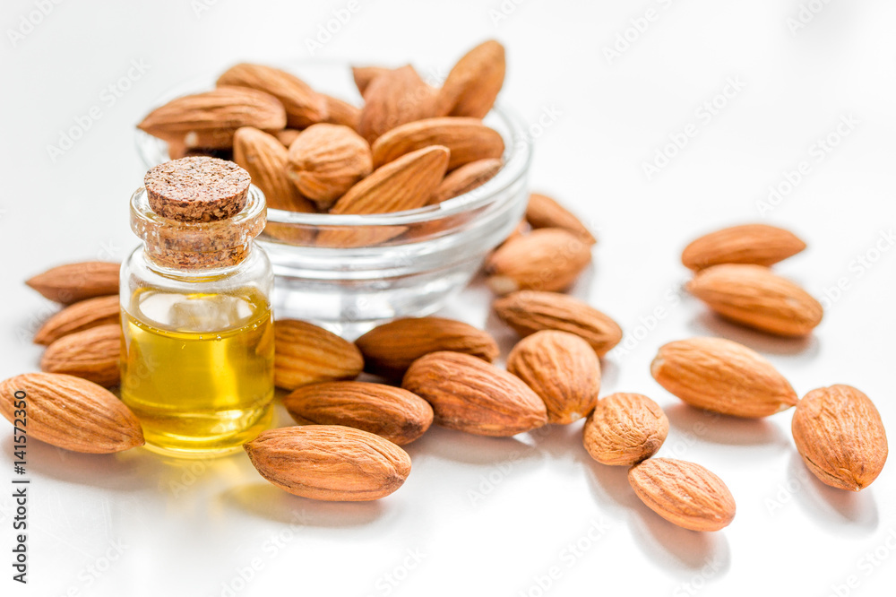 cosmetic set with almond oil on wooden table background