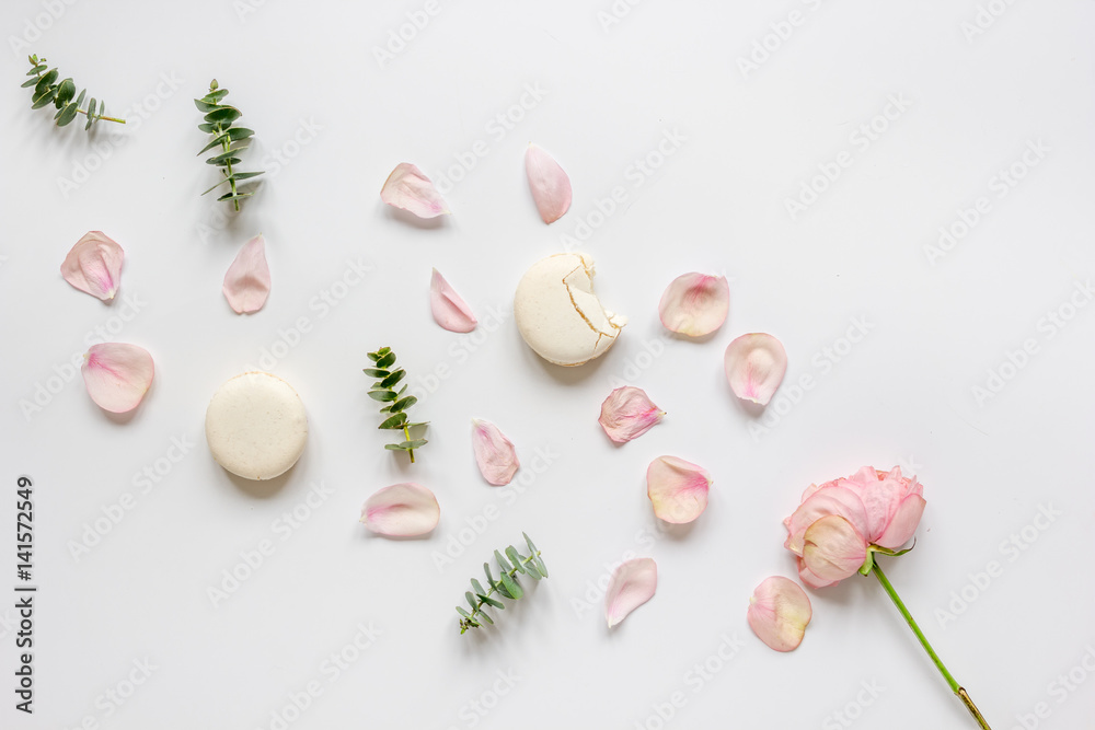 woman table with rose and macaroons in pastel color top view mockup