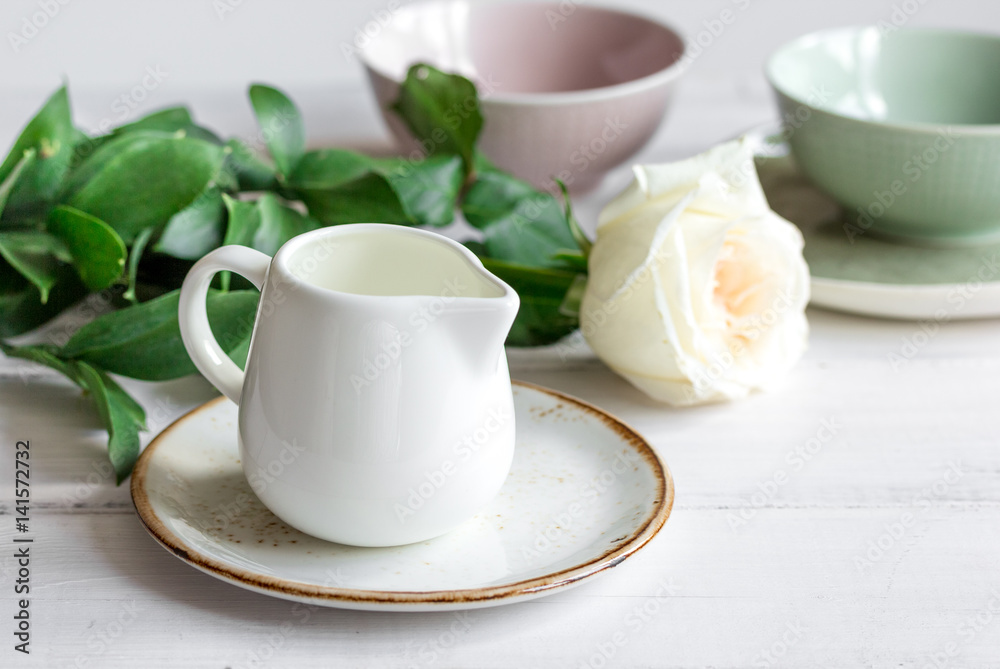 ceramic tableware with flowers on white background