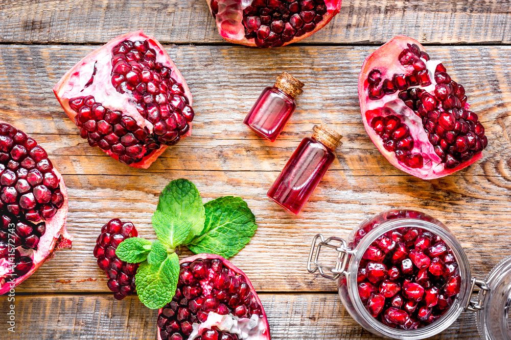 sliced pomegranate on wooden background top view