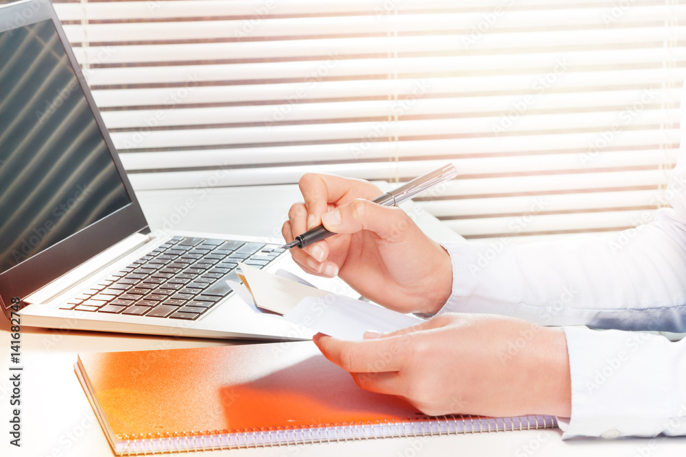 Woman working with papers and making notes