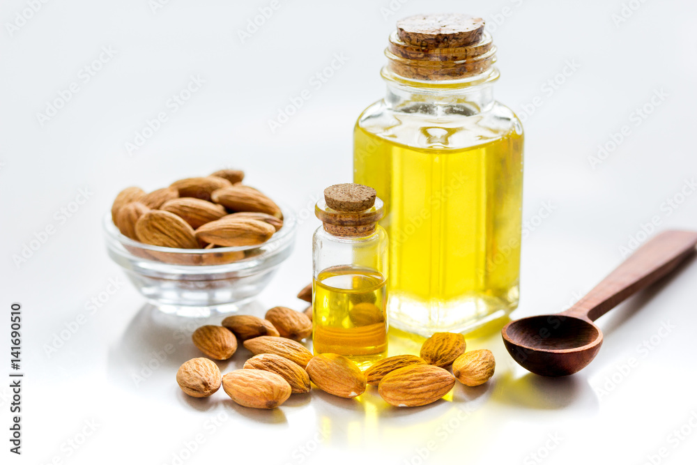 cosmetic and therapeutic almond oil on white background