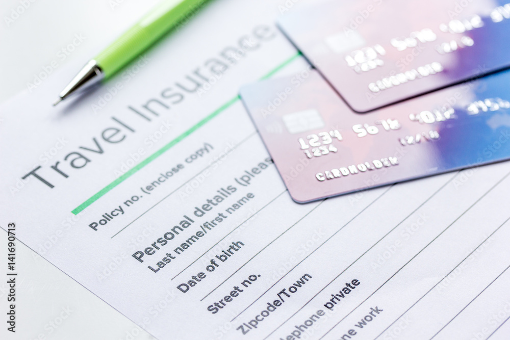 Traveling concept with insurance application on white table