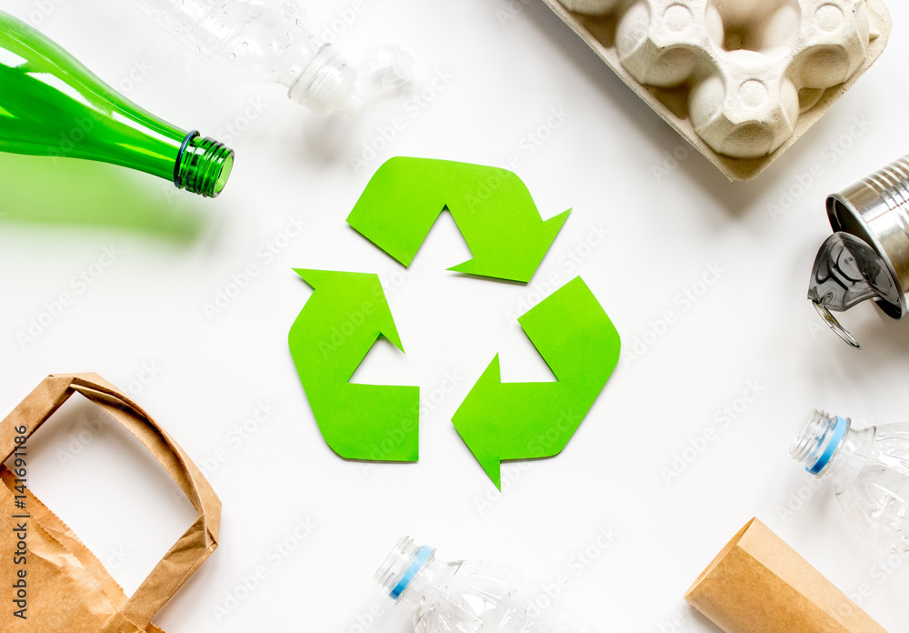 recycling symbol with waste on white background top view