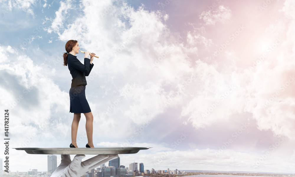 Attractive businesswoman on metal tray playing fife against cityscape background