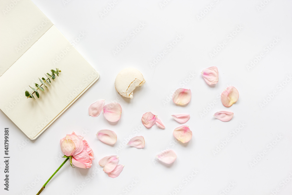 woman table with rose and notebook in pastel color top view mockup