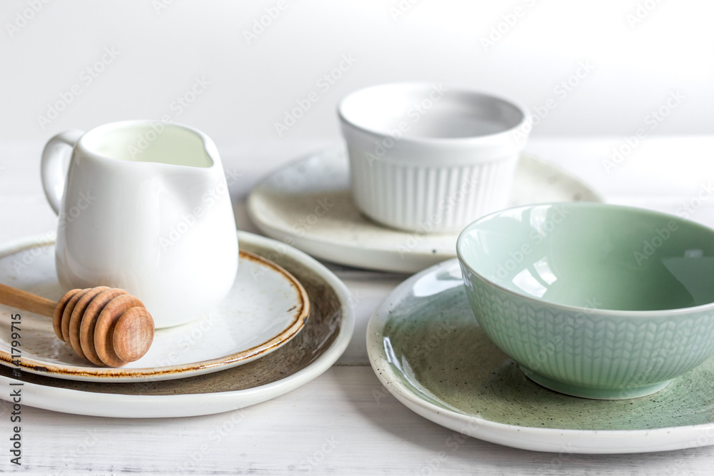 ceramic tableware with flowers on white background