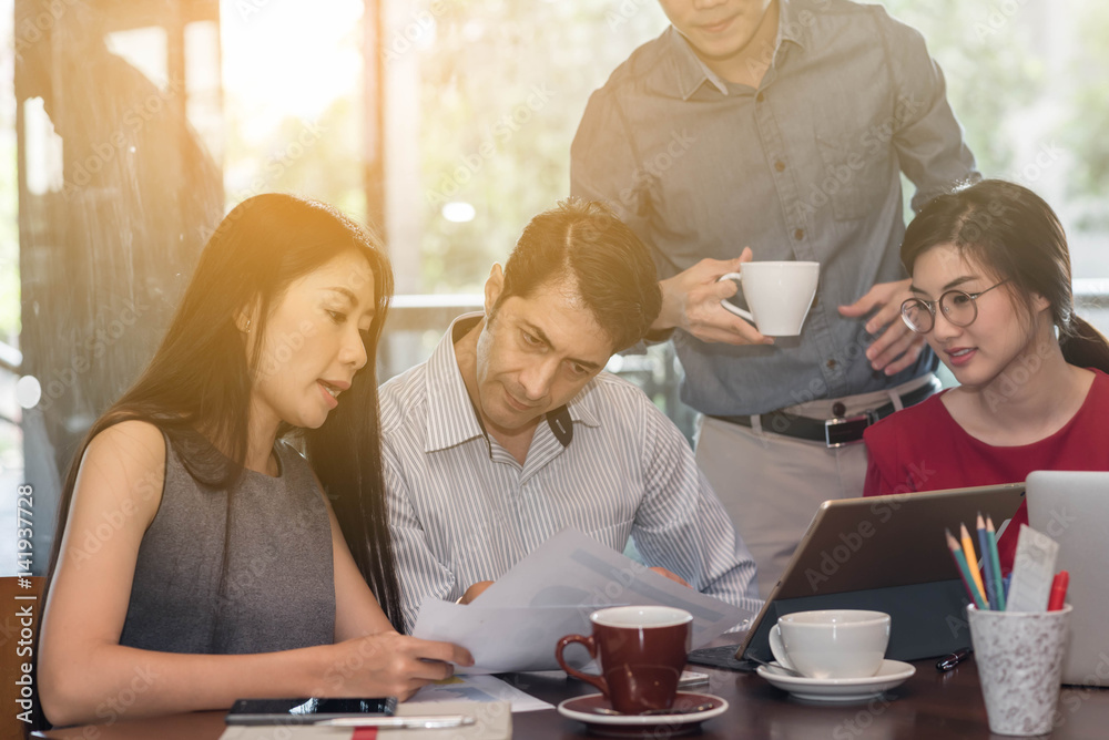 4 people meeting in coffee shop, business casual conceptual