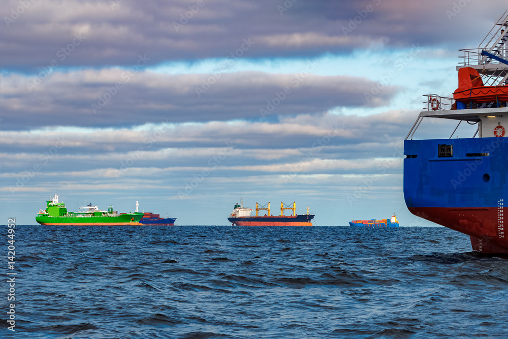 Cargo ships moored in still Baltic sea water