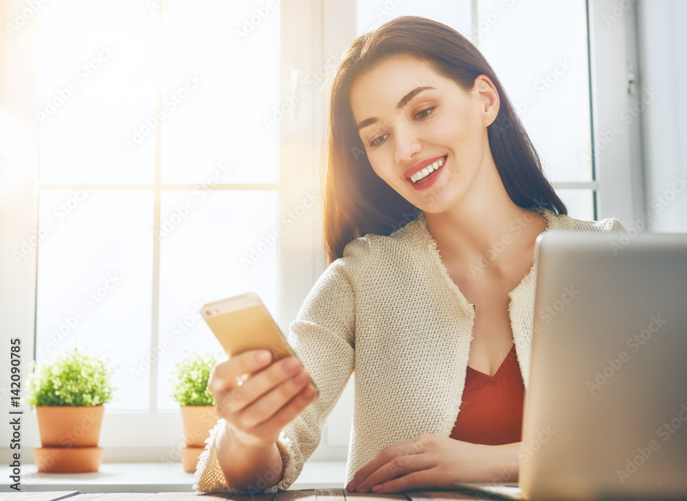 Woman is using phone.