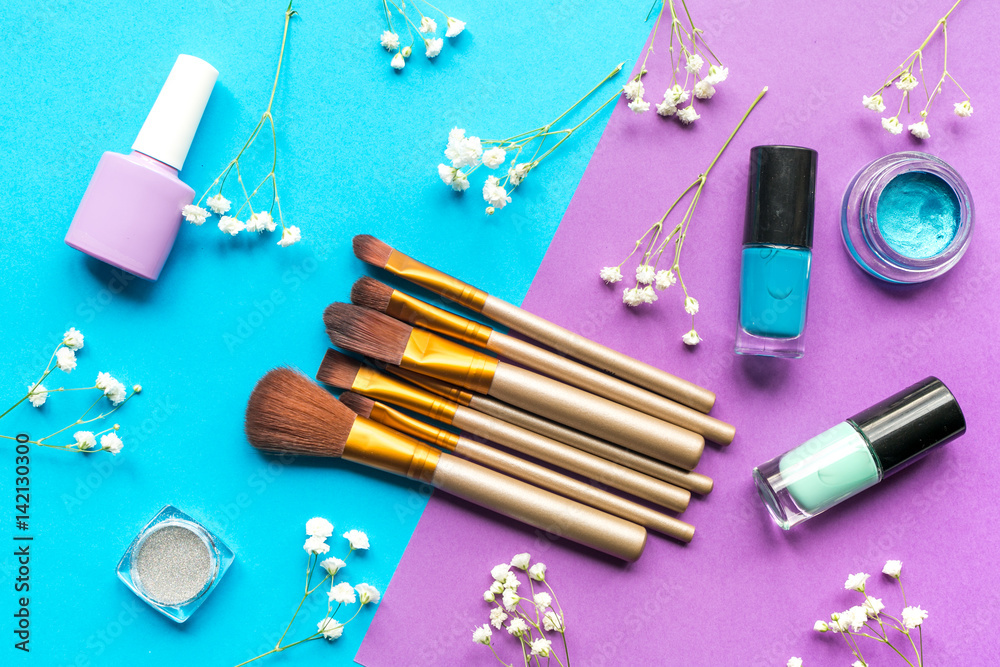 cosmetic set with brushes on woman table background top view