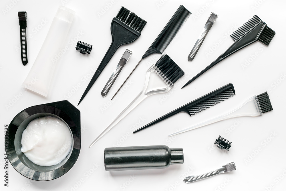 hair dye with brush on white table background top view