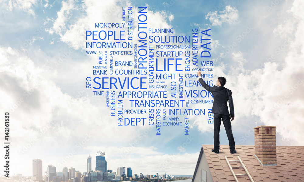 Young businessman standing on house roof and writing leadership 