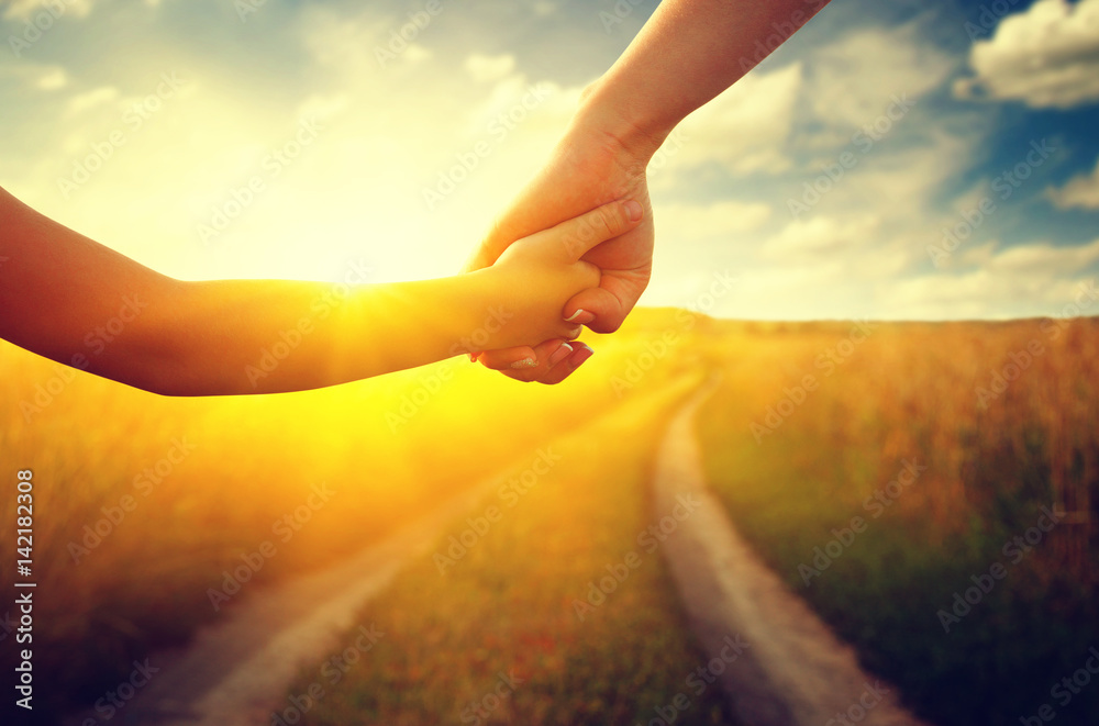 Hands of holding each other in field