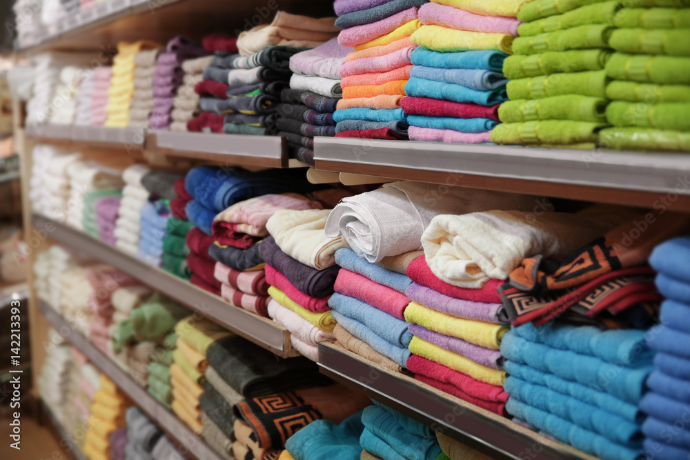 Shelves with towels in supermarket