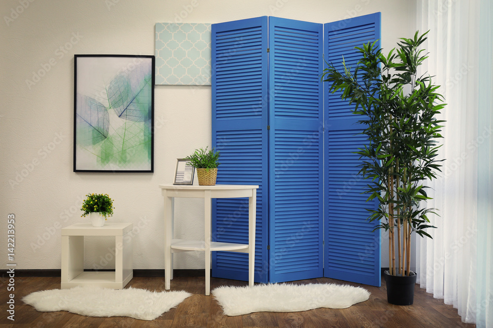 Light room interior with blue folding screen