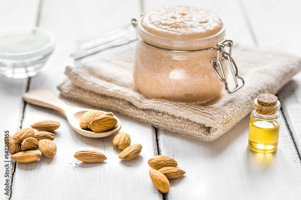 natural scrub with almond oil and sugar on light table background