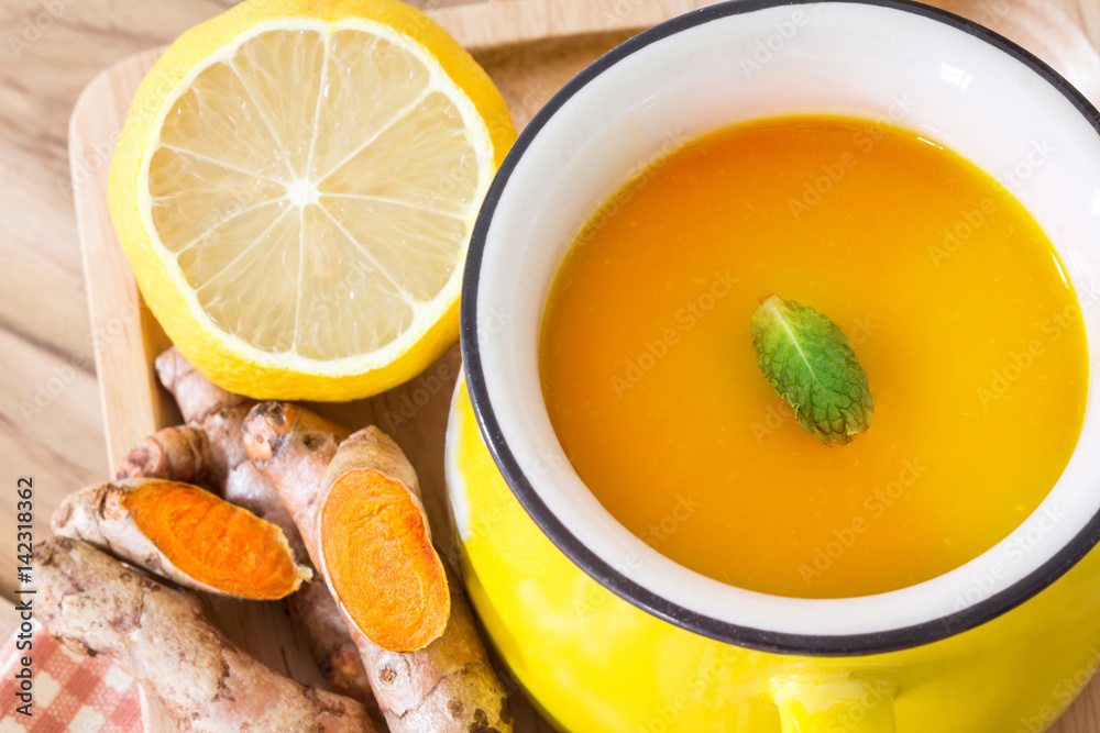 a cup of Turmeric Tea with lemon and ginger , Benefits for reduce Inflammation , Liver Detox and Cle