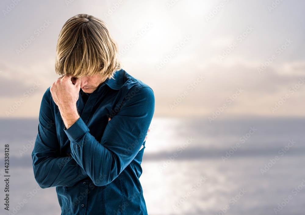 Sad depressed man in front of sea