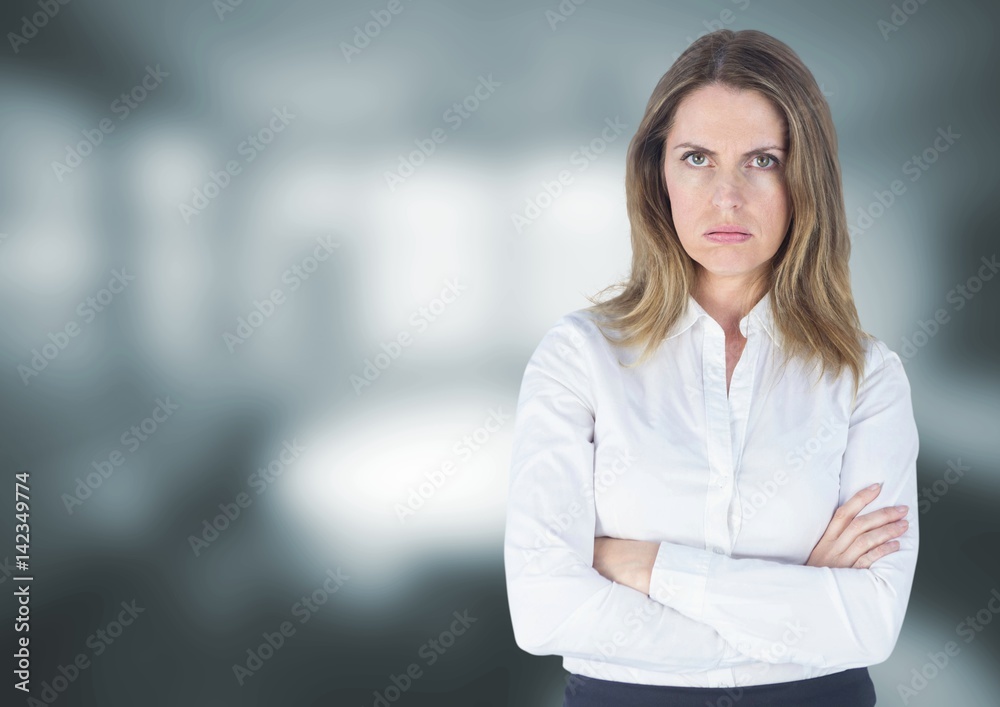 Angry disappointed businesswoman against grey blurred background