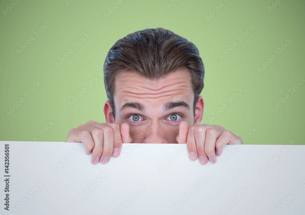 Man behind large blank card against green background