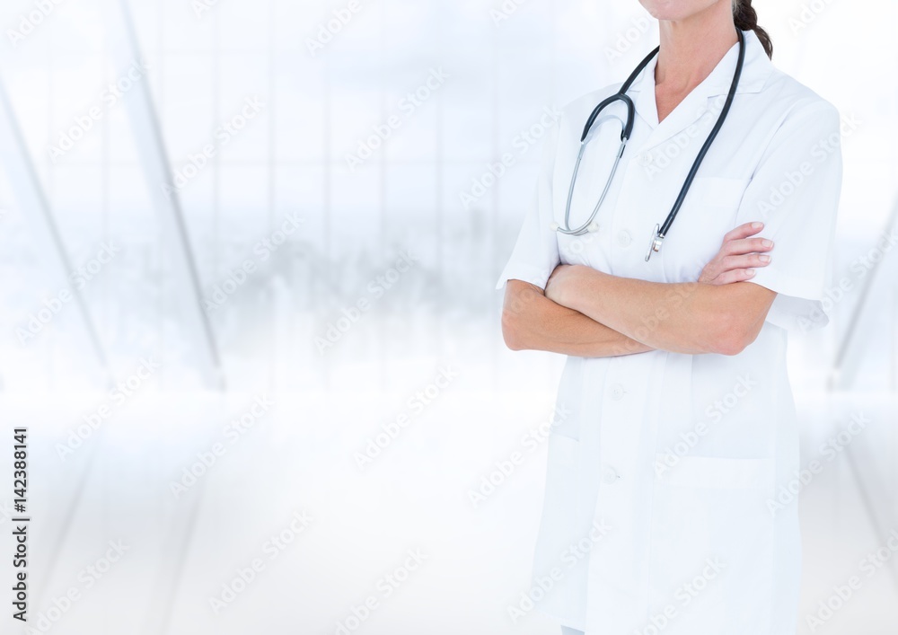 Doctor mid section with arms folded against blurry window