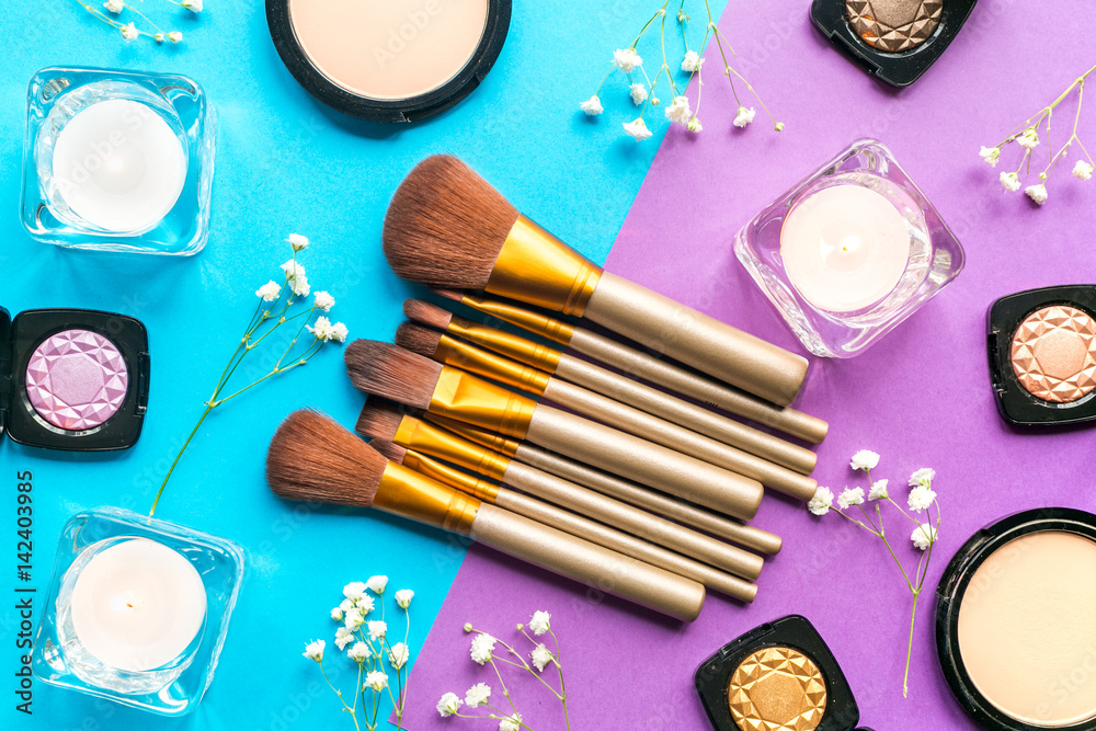 Beauty and fashion concept with decorative cosmetics on colorful background top view