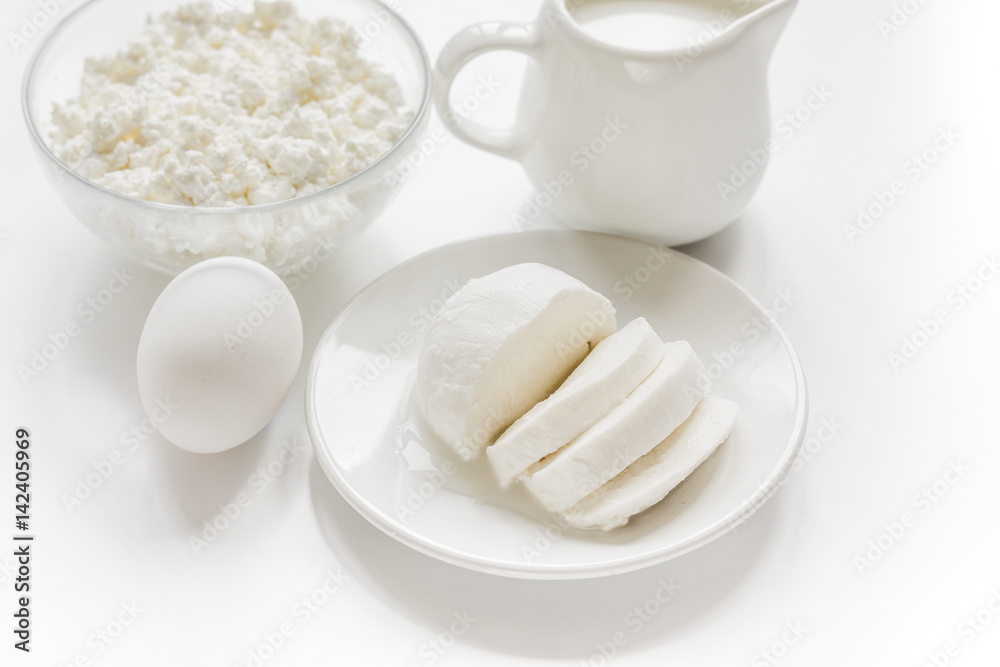 monochrome concept with dairy products on white table