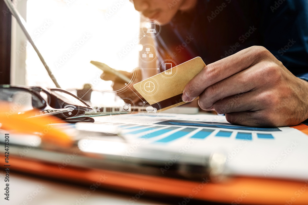 Business man hands using laptop and holding credit card with digital layer effect diagram as Online 