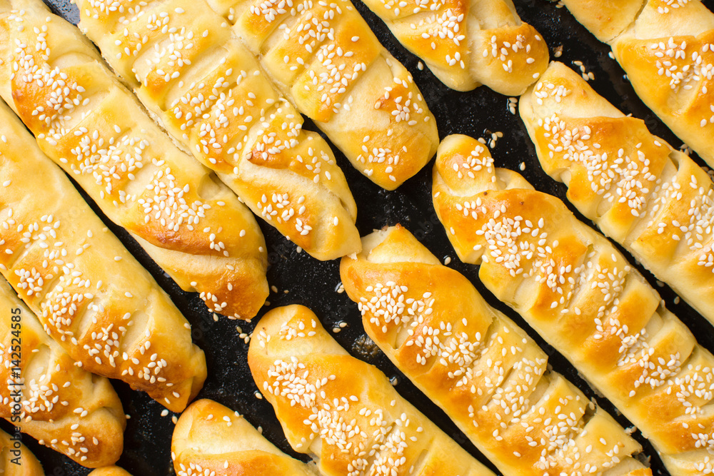 Homemade pastry on black baking pan