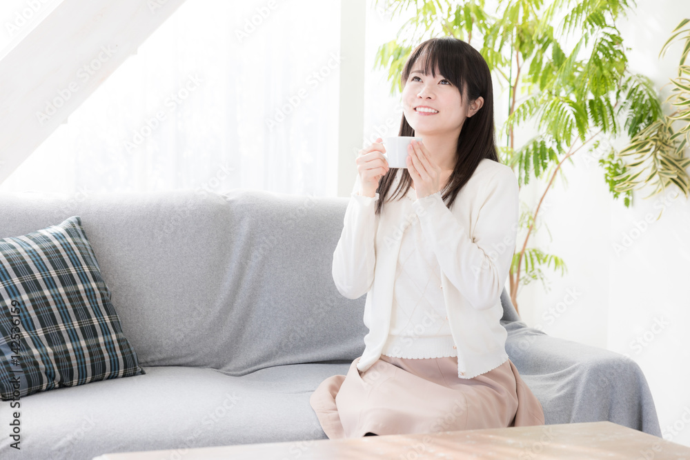 attractive asian woman relaxing in living room