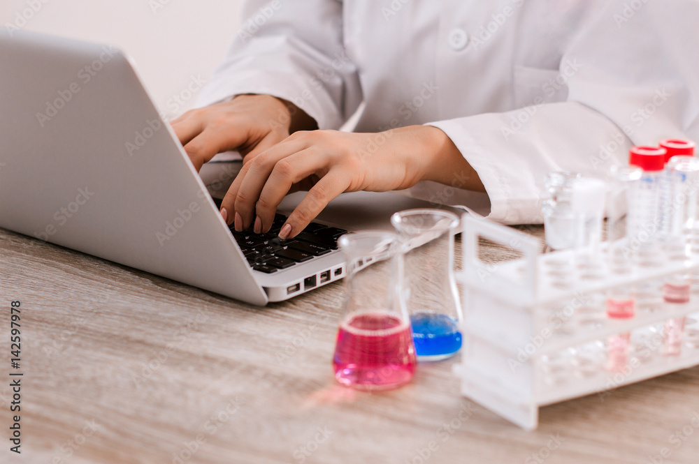 Scientist taking notes on his laptop