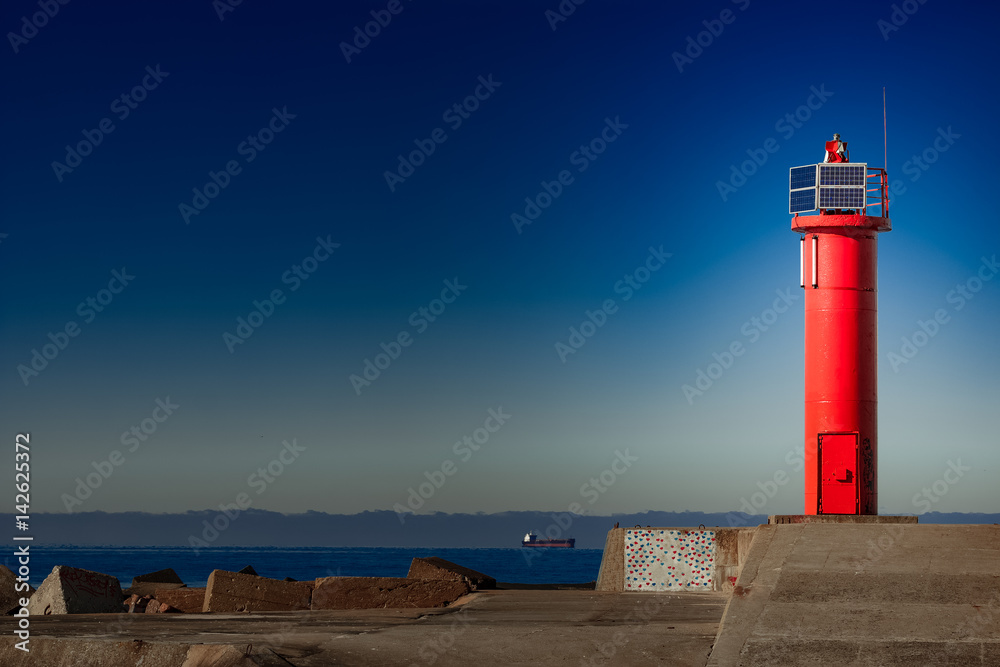 Red lighthouse on breakwater dam in Riga, Europe