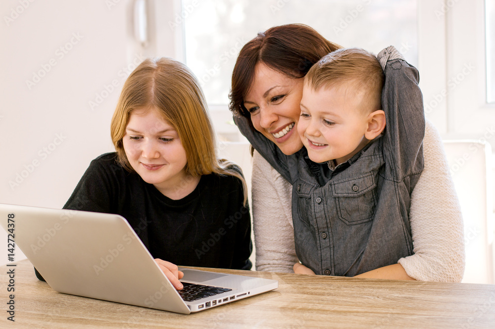 Mother and children web surfing at home