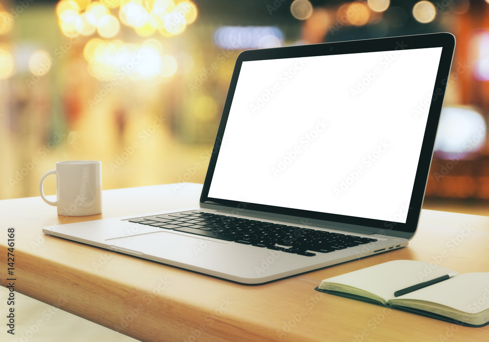 Blank white laptop on bokeh background