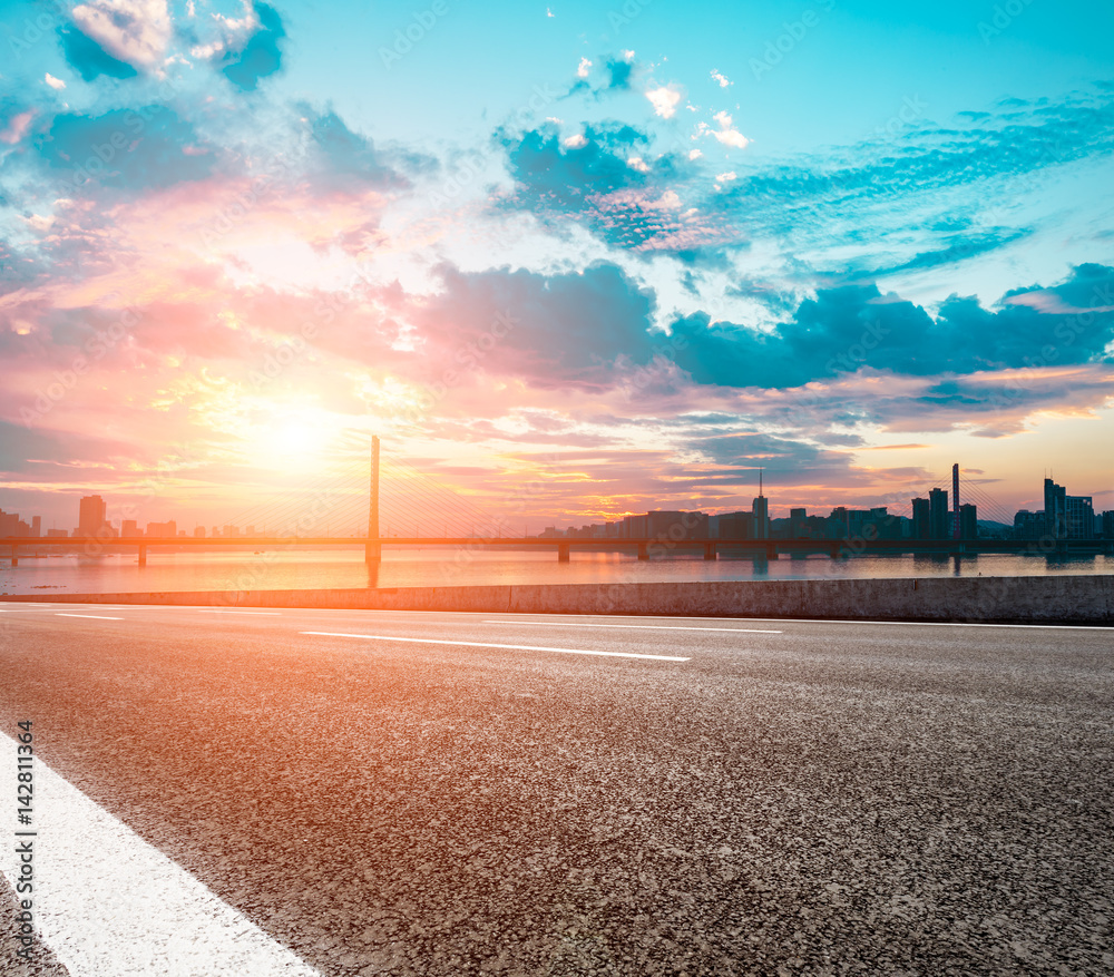 Asphalt road and beautiful sky at sunset