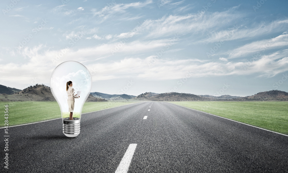 Businesswoman inside light bulb