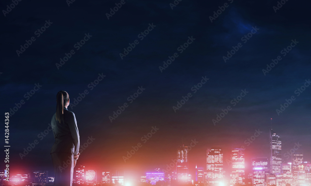 Woman looking at night city