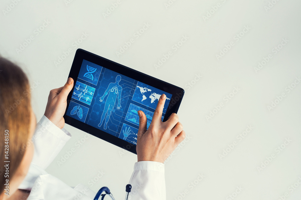 Close of female doctor hands working with tablet pc computer