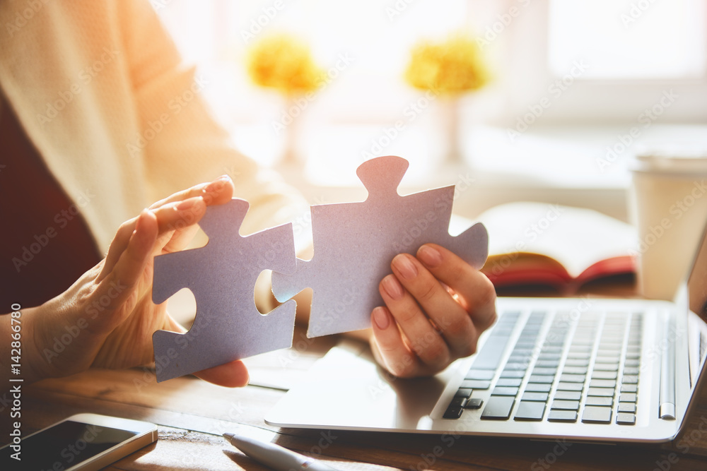 Woman connects couple puzzle piece