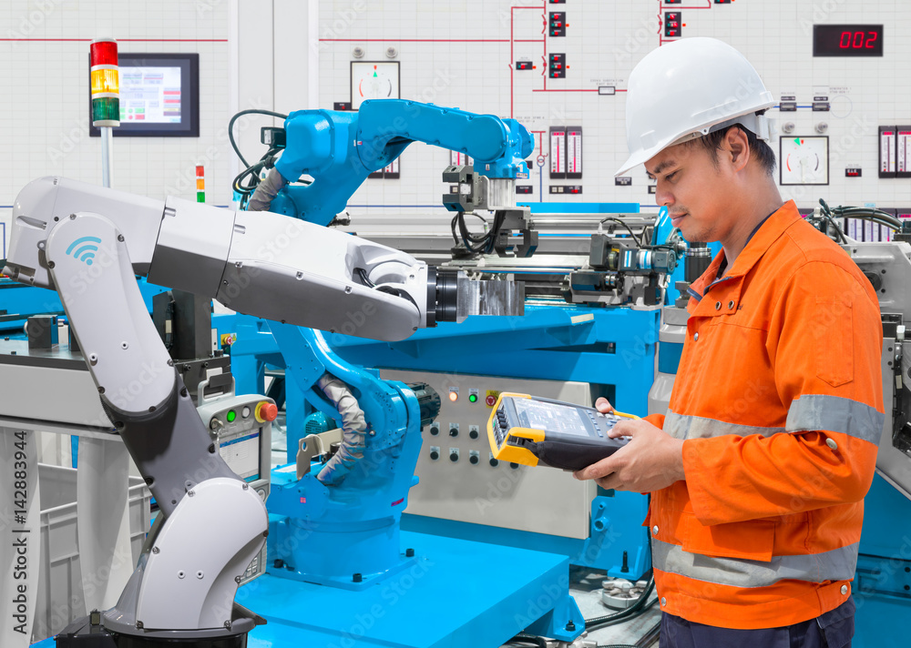 Maintenance engineer programing automated robotic at industry 4.0 concept