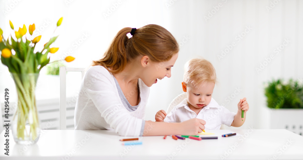 Mother with baby son with colored pencils