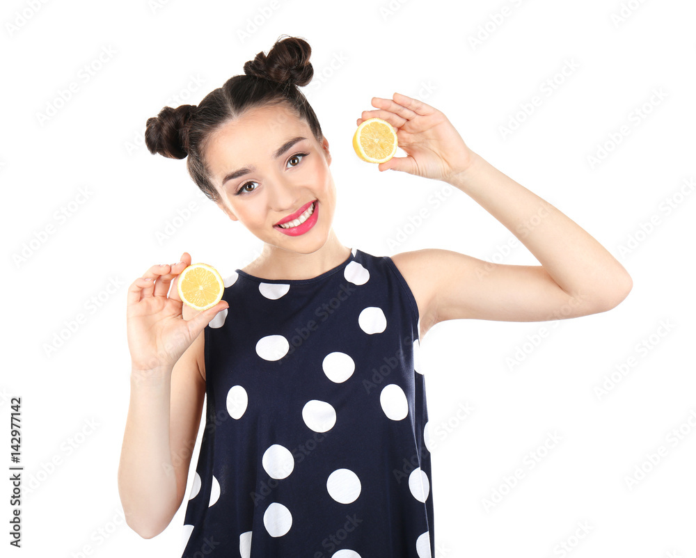 Beautiful young woman with lemon halves on white background