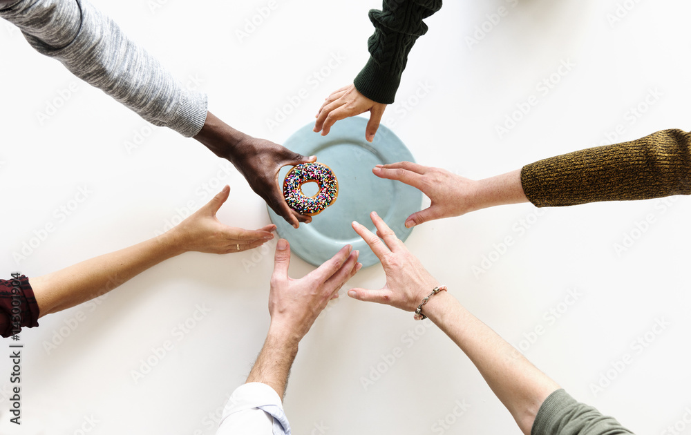 People Hands Reach for Last Doughnut