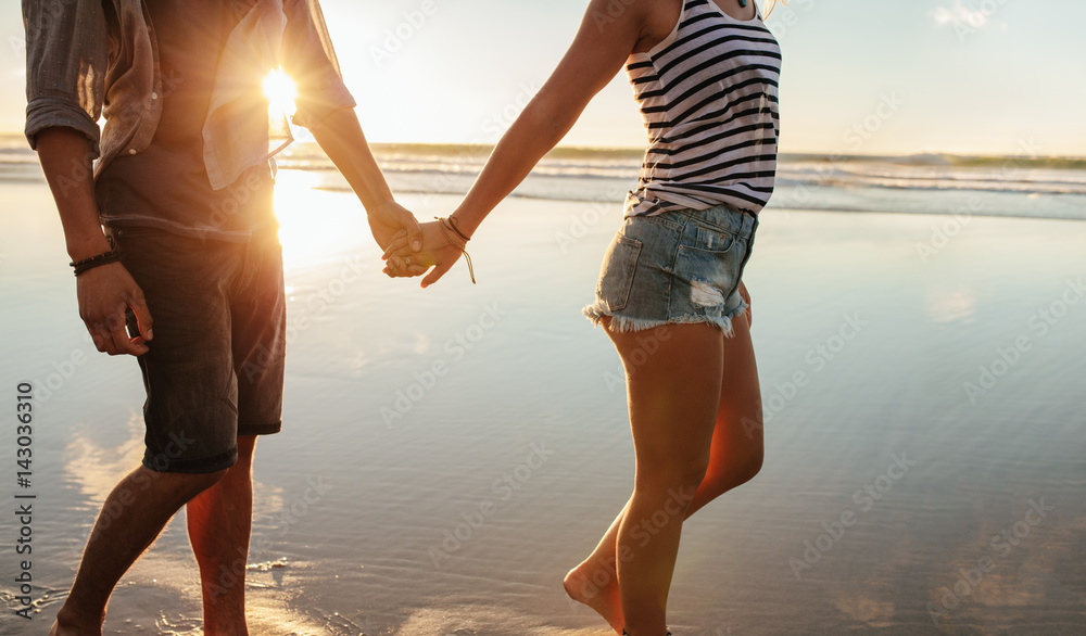 Loving couple strolling on the shore