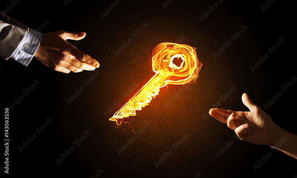 Concept of partnership and cooperation presented by fire glowing key icon