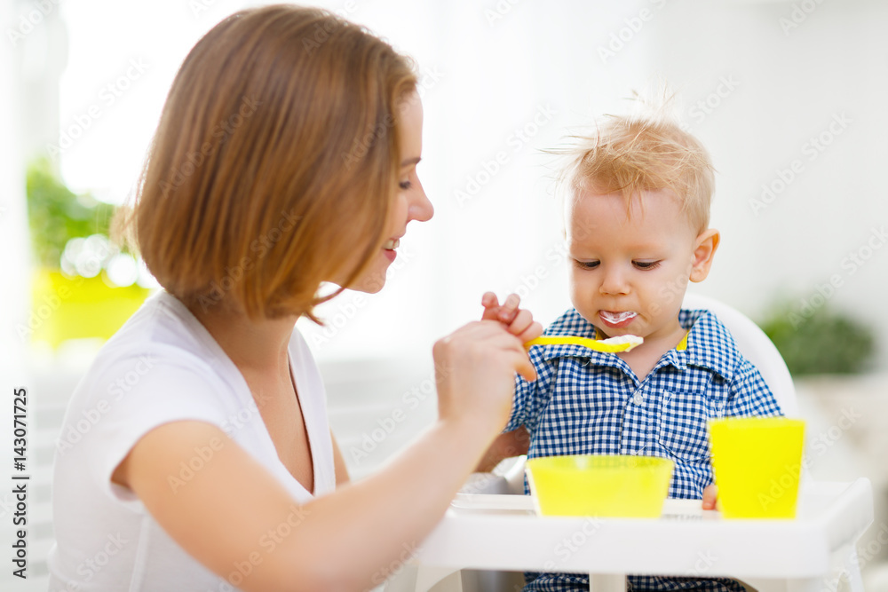 Mother feeds baby from spoon