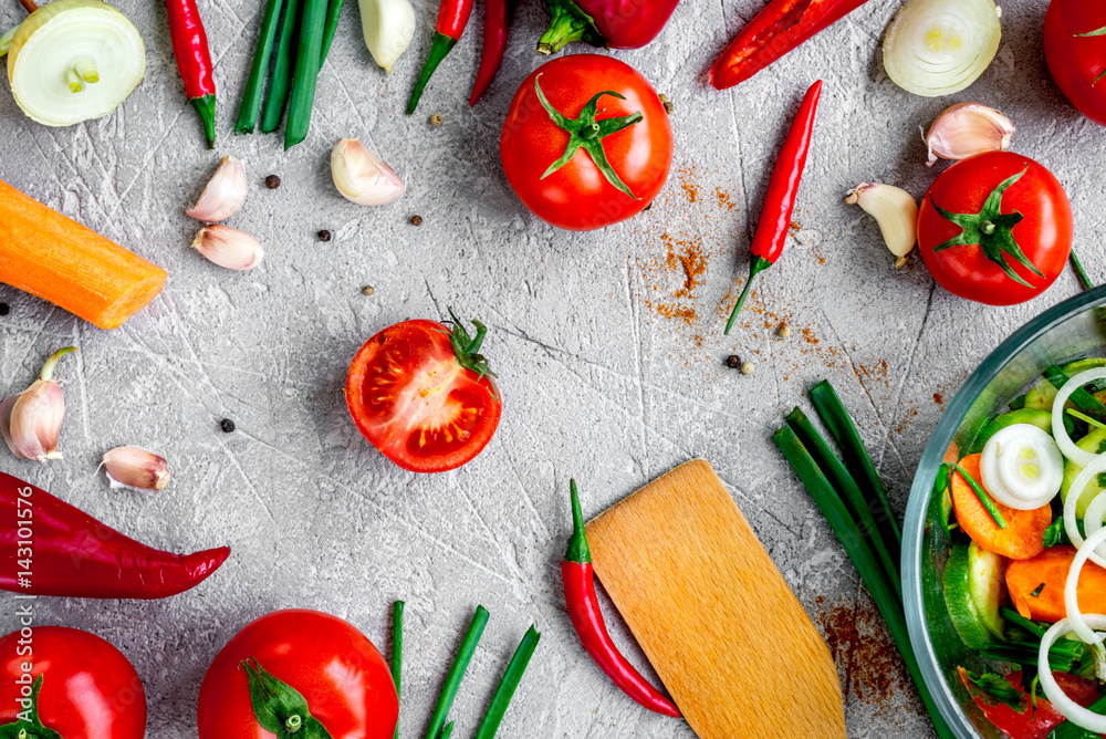 cooking vegetables on the stone background top view