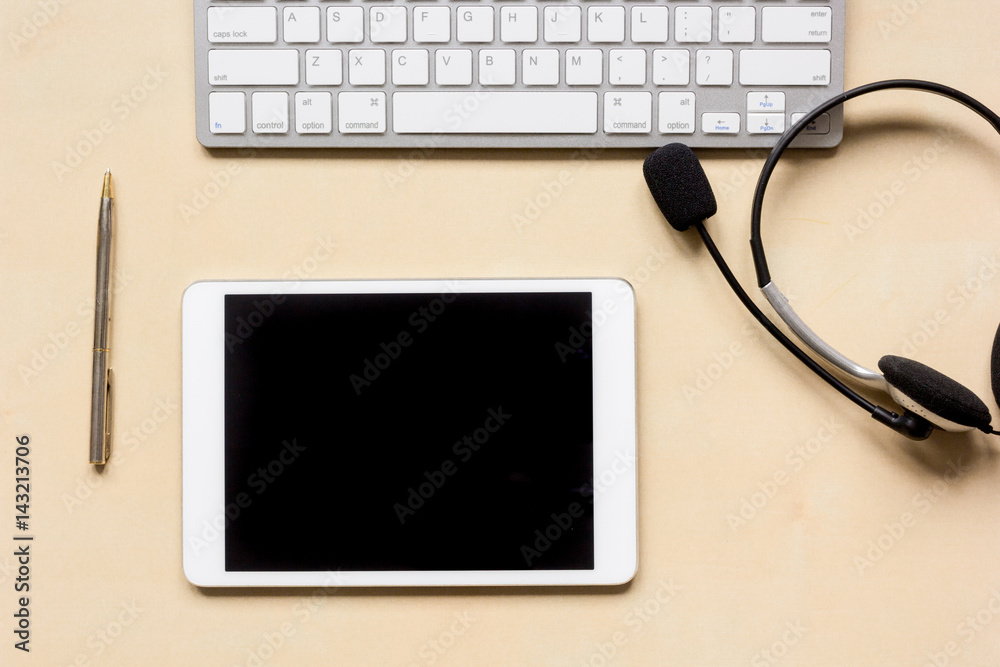 call center manager work desk with tablet and headset top view